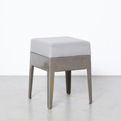 Nel Verschuuren Schouwburg Amstelveen Stool Joosten Projecten folded heavy gauge sheet steel clear coat one piece gun metal silver grey leatherette seat cushion sturdy minimalistic modern splayed legs custom made not commercially available heavy duty built to last solid stable made-to-order exclusive architect designed