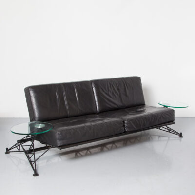 Industrial Space-Frame Couch side-table black leather cushions welded rod steel open construction round circle glass flat ground edges off-centre rotate builtin end-table Russian Constructivism lounge easy sofa seating modern contemporary