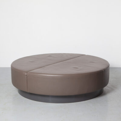 Supersized Pouf brown leather round shape large circle wood base padding seating bench lobby reception area museum expo hall lounge relax sex club communal couch sofa bed custom made hocker foot stool ottoman footrest tuffet salon table tray contemporary modern 2010s